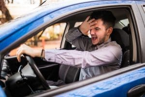 Frustrated handsome young man driving his car, Dangerous Driving Behaviours